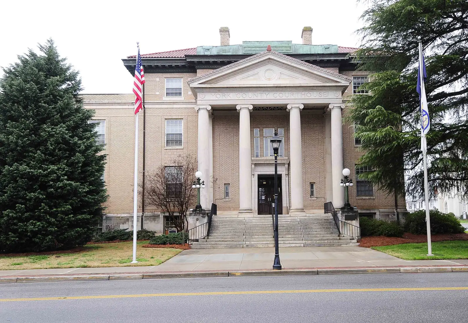 The York County Courthouse in York, SC, with its columned portico and flags out front